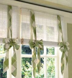 green and white bow tie curtains hanging in front of a window