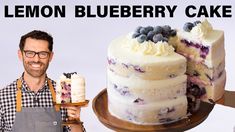 a man holding a cake with blueberries on it and the words lemon blueberry cake