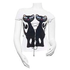 a mannequin wearing a white shirt with black cats on the front and back