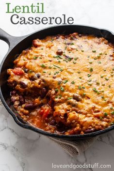 a casserole with meat and vegetables in a skillet on a marble surface