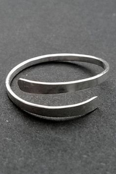 This hand hammered ring is small and meant to be worn as a Midi Ring or Toe Ring. US Ring size 3, adjustable from sizes 3-4 FOR FULL SIZE RING (Sizes 5-12) -> https://www.etsy.com/listing/899750825/sterling-silver-ring-hammered-silver Comfortable, Durable, and Slim 16 gauge Sterling Silver Adjustable, US Sizes 3-4 This adjustable Toe/Knuckle/Midi Ring is fully handmade and marked with a 925 which means 100% Solid .925 Sterling Silver Choose your style! You can wear this cute petite ring as a Coil Ring, Silver Leaf Ring, Petite Ring, Hammered Band, Hammered Rings, Choose Your Style, Midi Ring, Ring Hand, Hammered Metal