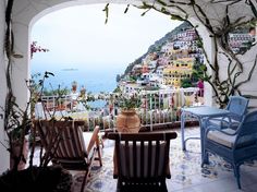 a magazine cover with two chairs and a table in front of a view of the ocean