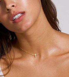 The prettiest Dainty Cross Choker, this 14k Solid Gold Cross Necklace is a special gift to yourself and others, a dainty cross surely to be a beautiful accent piece to any occasion!  This item ships within 1 business day. Model is wearing 15 inches in 14k solid gold. You can choose the center or the sideways design.  We beautifully package every item in a jewelry gift box. * All orders are hand crafted with care from our happy studio in sunny Miami, FL  * All items are ethically sourced by me for durability & perfect finishes * It's not only meant to look beautiful... it's meant to be meaningful * This item is a custom made item and is non-refundable  MIX & MATCH:  For cross hanging earrings click here: https://www.etsy.com/listing/770133263/cross-huggie-hoops-cross-earrings-cross?ga_searc Gold Cross Necklace For Women, Cross Necklace Gold, Cross Necklace For Women, Cross Choker Necklace, Tiny Cross Necklace, Dainty Cross Necklace, Dainty Choker Necklace, Cross Necklace Sideways, Cross Choker