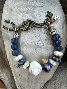 Artisan Blue Bracelets For The Beach, Artisan Blue Beaded Bracelets For Beach, Blue Beaded Bracelets With Natural Stones, Bohemian Blue Beaded Bracelets With Wooden Beads, Eclectic Blue Beaded Jewelry, Blue Bohemian Beaded Bracelets With Wooden Beads, Bohemian Blue Bracelets With Wooden Beads, Handmade Vintage Blue Beaded Bracelets, Unique Blue Bracelets With Large Beads