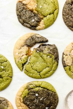 cookies with green and brown crumbs are on a white surface