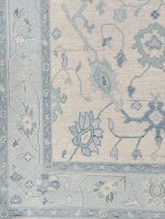 an area rug with blue and white flowers on it