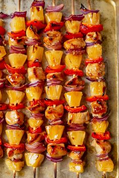 several skewered food items on a tray ready to be cooked in the oven