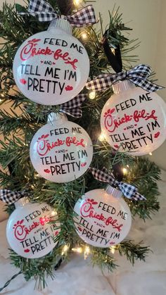 a christmas tree with ornaments that say feed me tell me i'm pretty