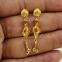 Elevate your style with these beautifully handcrafted gold earrings. Featuring a classic design and a comfortable fit, they add a refined touch to any look. Ideal for everyday wear or special occasions, they bring a subtle yet sophisticated sparkle. 18K Gold Dangle Earrings Metal is Real Gold Purity is 18kt Weight is 2.74 grams approx Max Length is 4.1 cm approx Max width is 0.7 cm approx ,  these earrings comes with normal backs, if you want real gold screw please contact. Please feel free to a Classic 22k Gold Hallmarked Earrings, Classic Hallmarked 22k Gold Earrings, 22k Gold Anniversary Earrings, Classic 22k Gold Earrings, 22k Yellow Gold Earrings For Anniversary, Elegant Gold Diamond Earrings As Gift, Simple Design 14k Gold Earrings, Classic 22k Gold Earrings For Formal Occasions, 22k Gold Bridal Drop Earrings