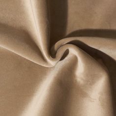 a close up shot of a plain tan fabric with very soft folds and wrinkles