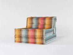 a multicolored chair sitting on top of a white floor