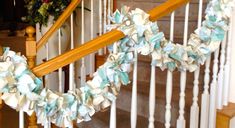 some white and blue flowers are on the banister