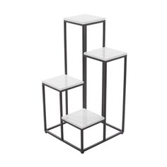 three black and white side tables with one on each side, the other off to the side