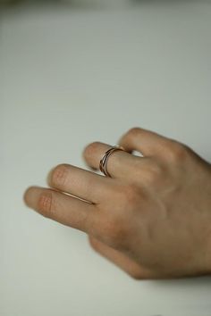 Two inseparable interlocking bands, one slender and the other almost twice the weight. The ring is available in two versions, one with a gold and sterling silver band, and the other with both bands in gold. A distinct and timeless piece from our most recent series of rings signifying closeness.This ring looks beautiful on its own, but it can be layered with other silver and gold pieces as well.Thinner band: 1.3mm, recycled 9k yellow gold / recycled 18k yellow goldHeavier band: 2.5mm, sterling si Silver 14k Gold Stackable Initial Ring, Silver 14k Gold Initial Ring For Everyday, Everyday Fine Jewelry Double Band Ring, Silver Midi Rings In 14k Gold, Open Band Design, Modern Twist Sterling Silver Stackable Rings In Yellow Gold, Adjustable Double Band White Gold Ring, Modern Twist Stackable Rings In Yellow Gold, Rose Gold Sterling Silver Open Band Ring, Modern Rose Gold Sterling Silver Ring