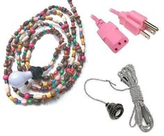 an assortment of colorful beads and wires on a white background, including a pink charger