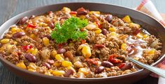 a large bowl filled with chili and corn