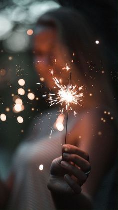 a person holding a sparkler in their hand