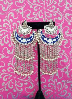 Gorgeous handmade long Indian meenakari dangly earrings, in chandbali design. Two tiers of dangling chains with pearl beads, suspended from colorful enamel crescent. Rows of clear crystals add bling. Feminine and so romantic They give a delicate effect. Lightweight and comfortable to wear. Weight is 8/10 ounce/ 23 grams. find even more great earrings here: https://www.etsy.com/shop/boutiquebymaryam?section_id=22797814 check out the rest of my shop here: https://www.etsy.com/shop/boutiquebymaryam Metal Chandbali Danglers With Meenakari, Metal Meenakari Chandbali Danglers, Chandbali Meenakari Danglers In Metal, Festival Chandbalis With Dangling Beads, Dangle Chandbalis With Latkans For Festivals, Festival Chandbali Earrings With Dangling Beads, Bollywood Chandbali Earrings With Dangling Beads, Metal Chandbalis With Meenakari, Bohemian Meenakari Chandbalis Drop Earrings