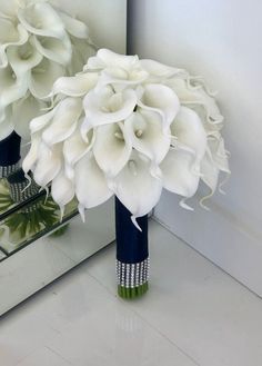 a bouquet of white flowers sitting in front of a mirror