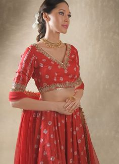 Step into elegance with the Red Embroidered Bandhani Satin Lehenga Set, a captivating blend of traditional charm and modern flair. Made from luxurious satin, the voluminous red lehenga showcases intricate layers of bandhani patterns, forming a timeless, flowing look enhanced by cancan for added volume and functional pockets for convenience. Paired with a striking V-neck blouse is embellished with shimmering mirrors, pearls, gold sequins, and delicate dori work, transforming the rich red fabric i Bandhani Lehenga, Pearl Mirror, Satin Lehenga, Hibiscus Red, Bridal Sarees South Indian, Add Sleeves, Red Lehenga, Indian Couture, Satin Blouses