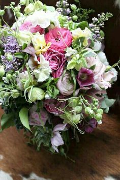 a bouquet of flowers sitting on top of a wooden table