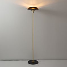 a floor lamp that is on top of a table