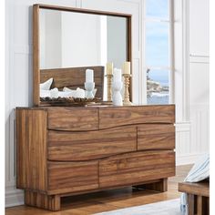 a wooden dresser with a mirror on top of it