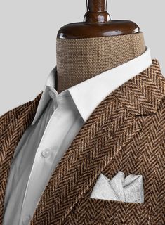 Unveil a legacy of style with our Harris Tweed Irish Brown Herringbone Suit, blending rugged charm with refined tailoring. Fashioned from pure wool, this suit features a herringbone weave that showcases a rich blend of earthy brown tones with intricate texture. The subtle pattern exudes timeless elegance, making it the perfect choice for any occasion. Whether you're attending a countryside wedding or stepping into a high-powered meeting, this suit ensures you stand out with confidence and class.  Look Includes    Harris Tweed Irish Brown Herringbone Fabric  Two Button Jacket Style  Notch Lapel   Horn   Brown  Buttons  Single Vent  Three Cuff Buttons  Two Welted Back Pockets on Trousers    Click 'Customize Now' to modify the look if needed.   Lining: Viscose, Dry Clean. Herringbone Suit, Herringbone Jacket, Subtle Pattern, Herringbone Fabric, Earthy Brown, Countryside Wedding, Button Jacket, Brown Tones, Harris Tweed