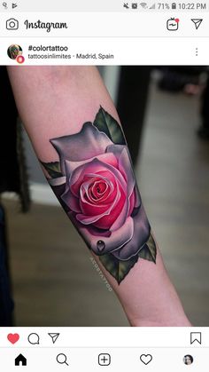 a pink rose tattoo on the arm