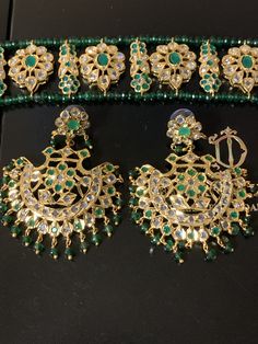 Ready to ship choker with earrings width of choker 1 inch length of choker 9 inch Length of earrings 2.5 inch width 2 inch made using onyx green beads with cz polki and 22ct gold plating delivered in 3-5 days within USA Green Hand Set Chandbalis For Festivals, Green Hand Set Chandbalis For Diwali, Festival Green Hand Set Chandbalis, Heavy Green Kundan Chandbalis, Green Cutdana Chandbalis For Party, Green Chandbali Jewelry For Diwali, Green Chandbalis With Stone Work In Temple Style, Green Temple Jewelry Chandbalis With Stone Work, Elegant Green Cutdana Choker