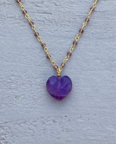 This necklace is handcrafted using a 2mm amethyst wire-wrapped chain and a 12mm faceted amethyst heart pendant. The amethyst is authentic and AAA quality. A gunmetal version is also available in my shop. Amethyst promotes peace, clarity and cleanses energy.  The necklace comes in a ribbon-wrapped box, ready to be gifted. If you would like to leave a note for the recipient, you can do so during checkout. Please note that each stone is unique and varies in color. Purple Heart Beads Necklace For Gift, Heart Shaped Amethyst For Jewelry Making, Heart-shaped Amethyst For Jewelry Making, Lavender Wire Wrapped Necklace For Gift, Handmade Heart-shaped Purple Jewelry, Handmade Heart-shaped Jewelry For Meditation, Handmade Purple Heart-shaped Jewelry, Purple Heart Pendant Necklace For Jewelry Making, Adjustable Heart-shaped Wire Wrapped Necklace