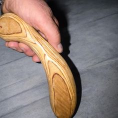 a person holding a wooden object in their hand