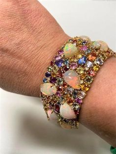 LAST CALL, LAST CHANCE LIQUIDATION SALE The Following Item we are offering is a Rare Important Radiant 18KT White Gold Large Fancy Fiery White Opal Diamond Multi Sapphire Bracelet. Bracelet is comprised of LARGE Gorgeous Fancy Fiery White Opals with Beautiful Glittering Diamonds and a Large Magnificent Gorgeous Array of Rare Multi Colored Sapphires. T.C.W APPROX 120 CTS Comes with New with Tags from a Private Manufacturer that sold to Important 5 Star Hotel and Fine Jewelry Stores. Original Reta Elegant Luxury Multi-stone Bracelet, Luxury Multicolor Jewelry With Motifs, Luxury Multicolor Jewelry For Ceremonial Occasions, Luxury Unique Bracelets With Colorful Beads, Luxury Multicolor Gemstone Beaded Bracelet, Luxury Multicolor Gold Plated Jewelry, Luxury Multi-stone Statement Bracelets, Luxury Multicolor Jewelry With Intricate Design, Luxury Multicolor Jewelry For Celebration