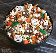 halloween snack mix in a black bowl with the words, halloween snack mix on it