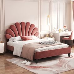 a bedroom with a pink bed, white walls and wooden floors is pictured in this image