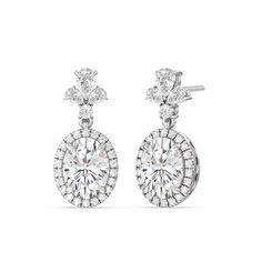 Elevate your style to new heights with our Large Oval with Halo Drop Earrings. These magnificent earrings are not just jewelry; they are a masterpiece that defines luxury and sophistication. With a combination of large oval diamonds, a stunning halo, and a diamond cluster top featuring a blend of pear and round-shaped diamonds, these earrings are a captivating statement of your unique taste and unmatched elegance. Luxury Oval Bridal Earrings For Formal Occasions, Luxury Oval Bridal Earrings With Prong Setting, Exquisite Oval Diamond Earrings For Anniversary, Exquisite Oval Diamond Earrings With Accents, Elegant Oval Diamond Earrings For Wedding, Elegant Oval Bridal Earrings For Formal Occasions, Elegant Bridal Earrings With Brilliant Cut In Oval Shape, Elegant Oval Diamond Earrings With Halo Setting, Elegant Oval Diamond Earrings