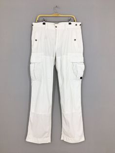 Size 36x32.5 Polo Ralph Lauren Cargo White Pants Casual Polo Ralph Lauren Pants Multi Pocket Utility Surplus Ralph Lauren Pant W36 Please contact me for any questions about this clothing before buying. SIZE MEASUREMENTS :- WAIST : 36" inches HIPS : 42" inches THIGH: 24" inches  LEG OPENING : 20" inches RISE : 11" inches INSEAM : 32.5" inches OUTSEAM (TOTAL LENGTH) : 43" inches WEIGHT : 0.76 kg Condition : Good Condition. No holes and no stains. Please pay close attention to measurements provided White Workwear Bottoms With Multiple Pockets, White Full Length Cargo Pants With Multiple Pockets, White Cargo Pants With Side Pockets, White Full Length Cargo Pants With Side Pockets, White Straight Leg Pants With Multiple Pockets, White Full Length Pants With Belt Loops, White Utility Full Length Cargo Pants, White Work Pants With Multiple Pockets, Fitted Straight Leg Work Pants With Multiple Pockets