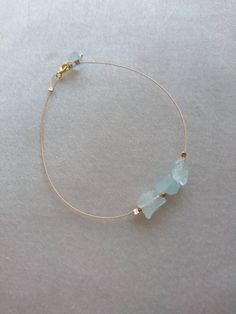 Dainty raw aquamarine bracelet with rose gold beads. Fluid 24k gold plated wire bracelet with stunning raw aquamarine nuggets and rose gold filled tiny beads. You could wear this bracelet every day. The mix of rose gold and the blue of the aquamarines is gorgeous. Modern, chic and pretty. Please choose your size from the drop down box. You can choose it to fit your wrist or allow it to drape. Thank you for visiting/purchasing DarlingGolightly. Aquamarine Bracelet Jewelry As A Gift, Aquamarine Bracelet Jewelry Gift, Handmade Aquamarine Bracelet, Rose Gold Wire Wrapped Bracelet, Wire Wrapped Rose Gold Bracelet, Minimalist Rose Gold Bracelet With Gemstone, Minimalist Rose Gold Gemstone Bracelet, Elegant Gold Aquamarine Bracelet, Dainty Aquamarine Gold Jewelry