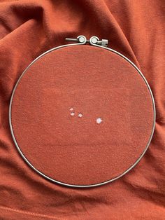 a close up of a circular object on a red cloth