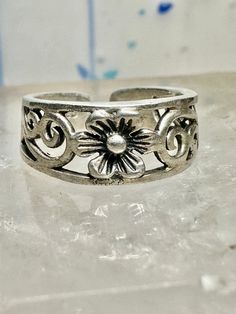 Toe ring flower floral scrollwork band size 3.50 sterling silver women  Size 3.50 adjustable Weight.   1.9g Width        1/4" Thinnest part  of band in back   3/16" Free Shipping & Free Postal Insurance  Delivered in a Gift Box  Let me know if you prefer the ring polished ... otherwise I wont as some people prefer patina .Will include a mini polishing cloth  Free First Class shipping and postal insurance is included. If you want to upgrade to priority kindly pay an additional fee to do so.  This Dainty Adjustable Silver Toe Rings, Adjustable Silver Dainty Toe Rings, Adjustable Flower Ring For Spring Wedding, Adjustable Silver Toe Rings For Anniversary, Silver Adjustable Toe Rings Stamped 925, Adjustable Silver Toe Rings Stamped 925, Adjustable Silver Bohemian Toe Rings, Bohemian Adjustable Flower Ring For Anniversary, Adjustable Toe Ring With Intricate Design