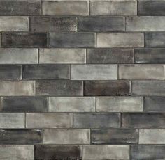 a gray brick wall that has been made out of concrete blocks and is very decorative