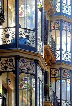 an ornate building with stained glass windows and balconies