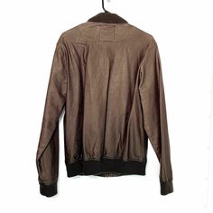 Stay stylish with this Five Four Men’s Faux Leather Bomber Jacket in size M (38-40). Featuring a sleek brown polyurethane exterior and a soft polyester lining, this jacket is perfect for casual wear. With a chest measurement of 42 inches and a length of 28 inches, it offers a comfortable fit. In Excellent Used Condition (EUC), this jacket includes ribbed cuffs and hem, giving it a classic bomber style while providing extra warmth and a snug fit. The full zip closure and side pockets add function Brown Collared Leather Jacket For Business, Brown Business Outerwear For Fall, Brown Outerwear For Business In Fall, Brown Urban Outerwear With Pockets, Classic Brown Leather Jacket For Winter, Urban Leather Jacket For Business In Fall, Urban Leather Jacket For Fall Business Wear, Brown Outerwear With Zip Fly For Work, Classic Brown Leather Jacket With Padded Collar