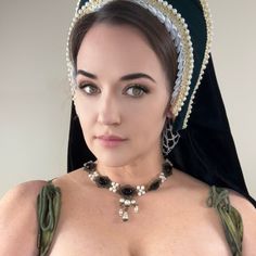 Handcrafted replica period jewelry, made to imitate the style and grandeur of the Tudors. This elegant necklace will complement any renaissance garb, and elevate even the most simple gown into a piece fit for a queen. It is made to order in your choice of gold, silver, or bronze and can be set with resin gemstones of just about any color. Ruby, emerald, sapphire, amethyst and onyx are most popular options.The Elizabeth is made with a row of stunning lace bordered cabochon bases, connected by clu Tudor Gown, Simple Gown, Period Jewelry, The Tudors, Simple Gowns, Tudor Style, Ruby Emerald, Elegant Necklace, Lace Border