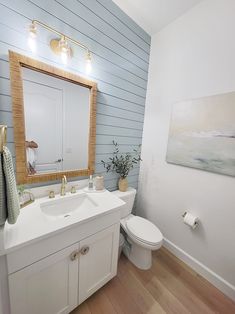 a bathroom with white walls and wood flooring is featured in the magazine mc interiors