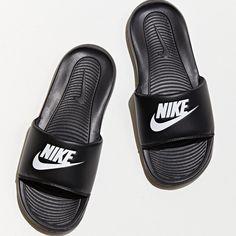 The Victori One Cn9675 Slide By Nike Features A Slip On Silhouette With A Padded Foot Strap And Comfy Cushioned Sole. Content + Care - Eva - Spot Clean - Imported Nike Casual Slip-on Flip Flops, Casual Nike Slip-on Flip Flops, Casual Nike Flip Flops, Nike Flip Flops For Summer, Nike Summer Flat Slides, Black Nike Synthetic Flip Flops, Nike Flat Flip Flops For Summer, Nike Black Slide Sandals, Nike Sporty Black Flip Flops