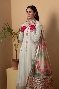 A long chiffon kalidar suit featuring similarly flared pants in shimmering golden silk. The suit features full mukesh work. Paired with a printed dupatta with with silver sequins.3-Piece SuitReady to wear Maxi Length Salwar Kameez With Mirror Work In Chanderi, Maxi Length Chanderi Salwar Kameez With Mirror Work, Chanderi Dupatta With Mirror Work Maxi Length, Silk Maxi Length Palazzo Set For Eid, Silk Palazzo Set With Dupatta In Maxi Length, Anarkali Style Tissue Silk Churidar With Mirror Work, Maxi Length Unstitched Suit With Dupatta For Diwali, Traditional Silk Lawn Suit With Mirror Work, Silk Lawn Suit With Sheer Dupatta For Party