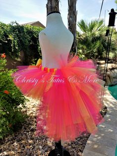 "These Tutus are so much fun to create! Not one is exactly like another! These are designed to mimic the Unicorn Mane or Tail. or can be used to mimic a Peacock Feather Spread, Done in any color(s) you like, we can create the perfect look you are looking for! This particular look is done with a mixture of Hot Pink, Coral and Bright Yellow. It is seen with a double layer of tulle for the front half, and the back half has several layers of different lengths to create the \"mane\" or \"tail.\" Then Pink Summer Tutu Dress For Costume Party, Pink Tutu Dress For Summer Costume Party, Pink Fun Tulle Tutu Dress, Fun Pink Tulle Tutu Dress, Fun Fitted Tutu Dress For Party, Pink Fitted Tutu Dress For Halloween, Orange Summer Party Tutu Dress, Fitted Multicolor Tutu Dress For Fun, Fun Fitted Multicolor Tutu Dress