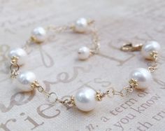 Beautifully polished white cultured pearls create a classic and elegant bracelet for a June born woman since pearl is her traditional birthstone. Genuine natural freshwater pearls are carefully hand wire wrapped with 14k gold filled wire and finished with a gold filled clasp and chain extender for the perfect fit every time.  Give a thoughtful high quality real pearl gift for mom who loves pearls or for your bride who loves dressy classic pearl jewelry. Gorgeous accessory for a little black dres Pearl Drop Round Bracelets For Anniversary, Pearl Bracelet For Anniversary, Adjustable Classic Pearl Bracelet For Anniversary, Classic Adjustable Pearl Bracelet For Anniversary, Anniversary Akoya Pearl Bracelet In Pearl White, Delicate White Bracelet For Anniversary, Classic White Pearl Bracelet For Wedding, Pearl Bracelet With Charm For Anniversary, Adjustable White Pearl Bracelet For Anniversary