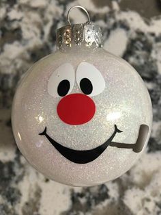 a glass ornament with a smiling face